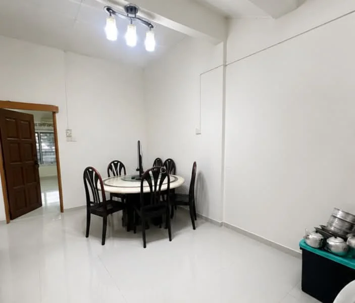 Dining features: round dining table, 6 dining chairs, white walls, white tiled flooring, ceiling light fixture with 4 bulbs, doorway leading to another room, corner storage box, metal cookware stacked; style: modern.
