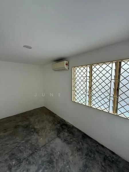 Room features: white painted walls, concrete flooring, 1 wall-mounted split AC, grilled window with metal frame, natural light from window, ceiling light.