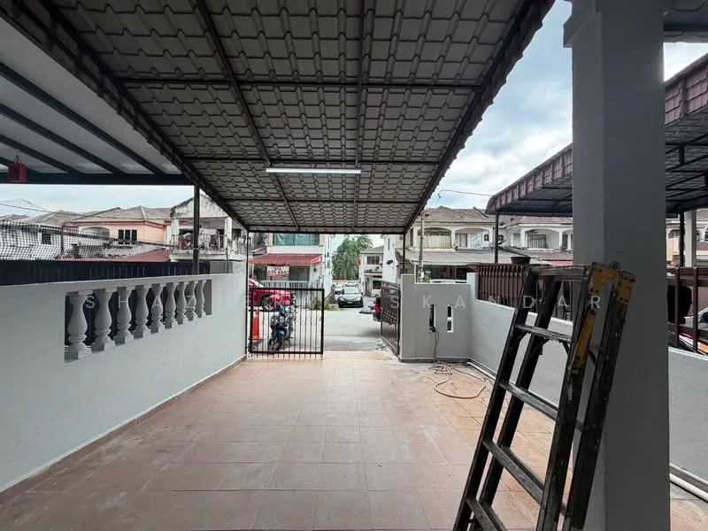 Exterior type: linked terrace house; features: covered car porch, tiled flooring, metal roof, security gate, fenced perimeter, balustrade with decorative design, driveway with interlocking pavers, surrounded by residential houses; style: modern.