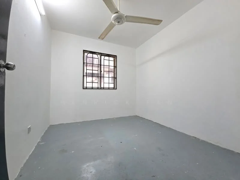 Room features: white painted walls, concrete flooring, ceiling fan, single window with metal grille.