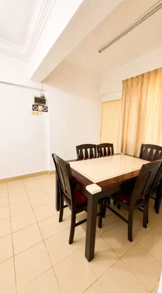 Dining features: square dining table with cream tabletop, 4 black wooden dining chairs with red cushions, cream tiled flooring, white painted walls, curtains in light brown fabric, crown moulding on ceiling, light fixture on ceiling; style: modern.