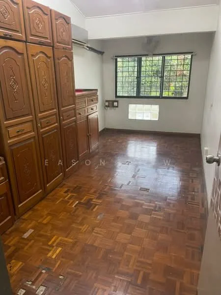 Room features: wooden cabinetry with decorative carvings, parquet wood flooring, large window with grid pattern, wall-mounted electrical outlets, neutral painted walls, ceiling with no visible features, natural light from window; view: garden.