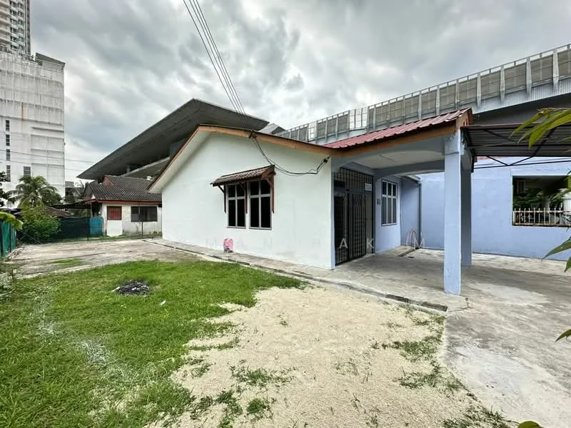 Exterior type: detached bungalow; features: white painted facade, red tiled roof, single-storey, concrete driveway, manicured lawn, surrounded by greenery, adjacent to multi-storey building, open car porch; style: modern.