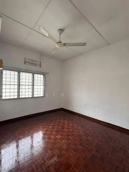 Room features: white painted walls, parquet wood flooring, ceiling fan, window with grilles, natural light from window.