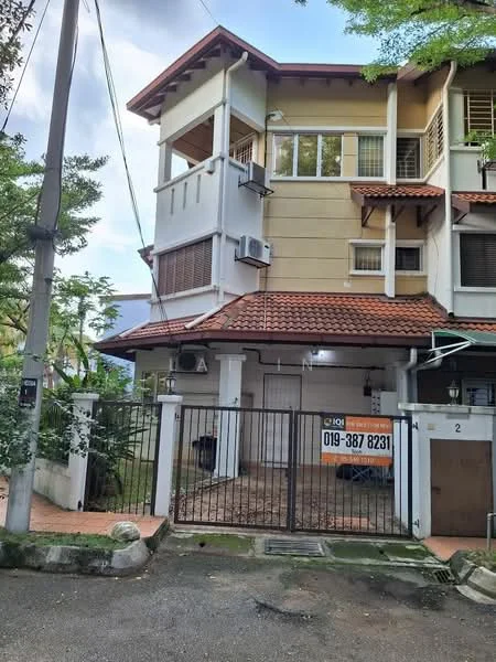 Exterior type: linked terrace house; features: two-storey building, red tiled roof, cream painted facade, exposed brick elements, balcony on the upper floor, two wall-mounted split AC units, gated entrance, manicured landscaping, paved driveway, fenced perimeter; style: modern.