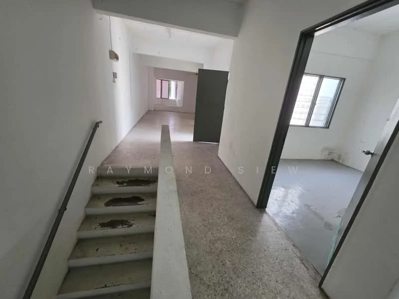 Room features: white painted walls, concrete flooring, staircase with metal railing, window with vertical blinds, door with handle, light fixture on ceiling.