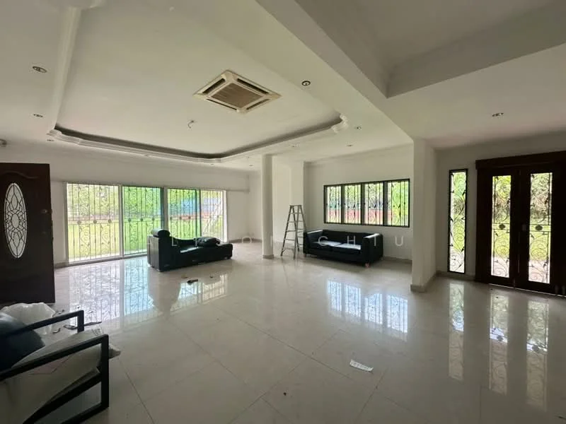 Living features: white painted walls, polished marble flooring, tray ceiling with recessed lighting, floor-to-ceiling windows, black leather sofa, black armchair, decorative wrought iron window grilles, air conditioning unit, natural light from windows, ladder in the corner; style: modern; view: garden.