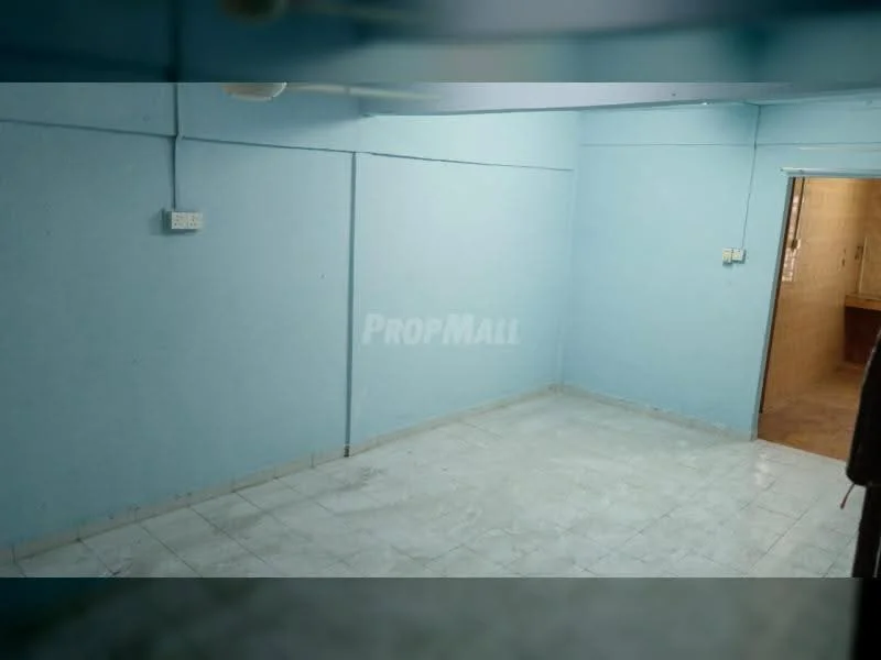 Room features: light blue painted walls, white tiled flooring, ceiling fan, doorway leading to another room, no visible furniture, corner wall with electrical outlets, plain ceiling, no windows visible.
