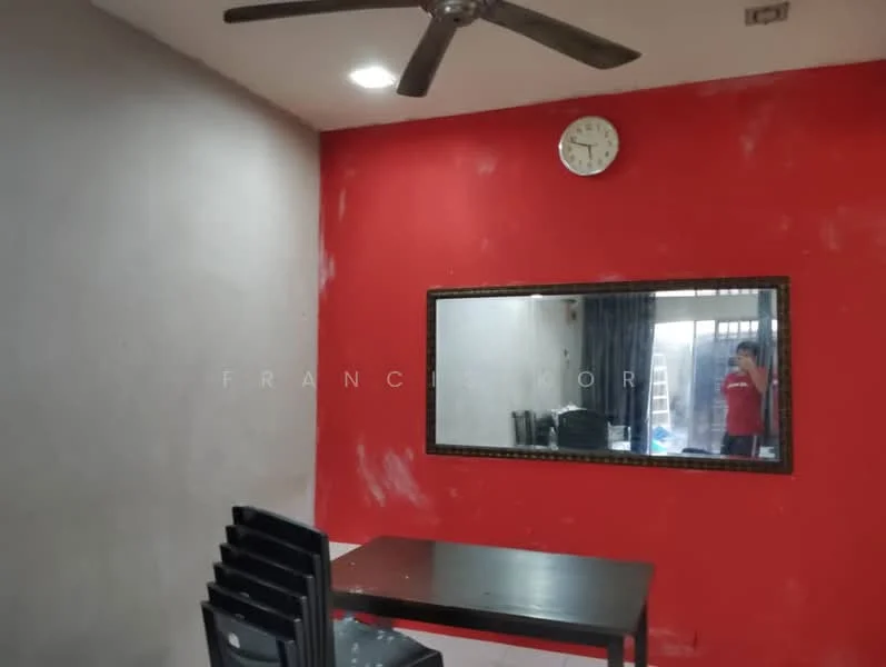 Room features: red accent wall, grey painted walls, ceiling fan, wall clock, mirror, dining table, black dining chairs, curtains, flooring not visible.