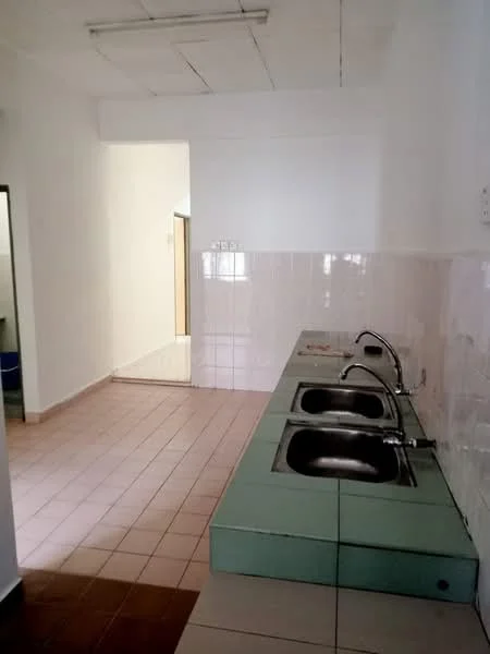 Laundry features: green countertop, three single-bowl stainless-steel sinks, white tiled walls, light brown tiled flooring, fluorescent ceiling lights, open doorway leading to another room.
