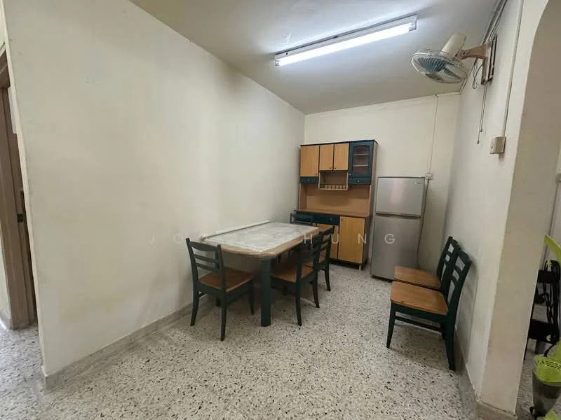 Dining features: table with marble top, 4 wooden dining chairs, wooden cabinetry with upper shelves, stainless-steel fridge, ceiling fan, white painted walls, speckled tile flooring, fluorescent ceiling lights.