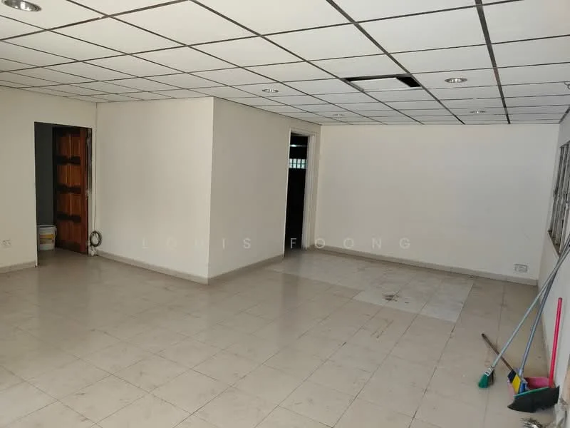 Room features: white painted walls, tile flooring, drop ceiling with recessed lights, multiple light fixtures, doorway leading to another room, window with no visible treatment, clean and empty space, corner broom and mop visible.