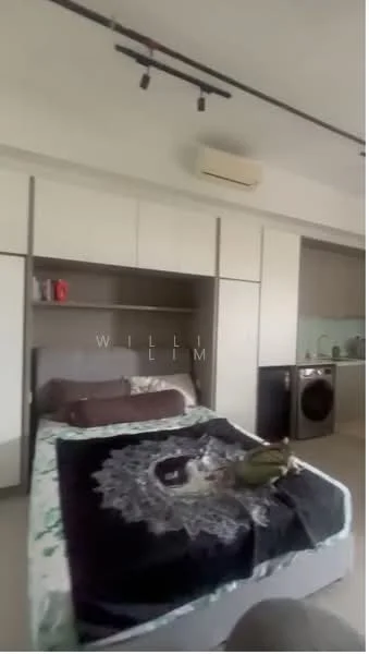 Bedroom features: queen-size bed with patterned bedding, built-in wardrobe with sliding doors, wall-mounted air conditioning unit, recessed lighting, neutral wall color, laminate flooring, decorative wall art, washing machine in corner, open kitchen area visible, small table or countertop, shelf with decorative items; style: modern.