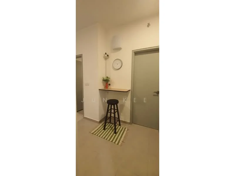 Room features: light grey walls, cream ceiling, flooring with light grey tiles, small wooden bar counter, black bar stool, green and white striped rug, wall clock, small potted plant on counter, door with grey finish, wall-mounted air conditioning unit; style: modern.