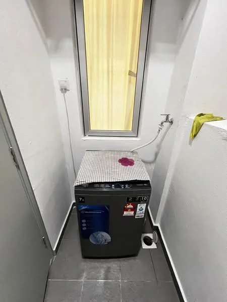 Laundry features: top-load washing machine, grey appliance, tile flooring, white painted walls, window with sheer curtains, plumbing connection, small space, checkered tablecloth on top of machine.