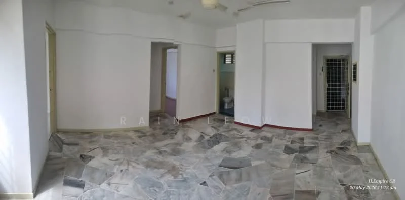Room features: white painted walls, marble flooring, ceiling fan, doorway leading to another room, window with grille, light switch, corner wall, red trim at the base of the walls.