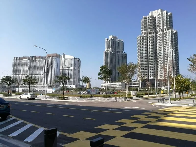 Exterior type: high-rise condominium; features: multiple high-rise buildings, glass curtain wall, manicured landscaping, paved walkways, surrounded by greenery, urban setting, clear blue sky, street view with road markings; style: modern.