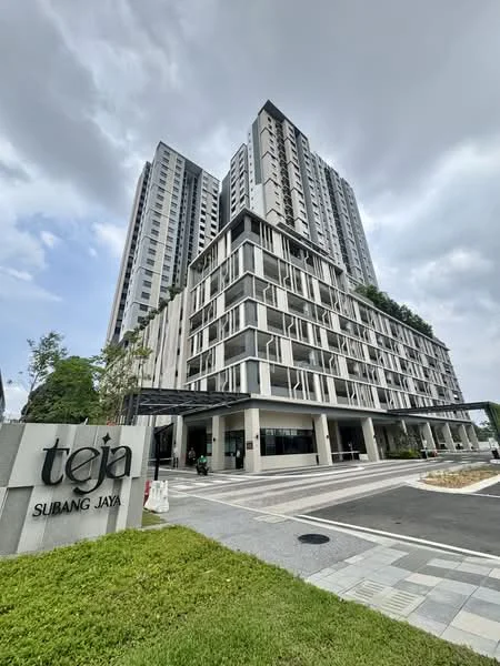 Exterior type: high-rise condominium; features: glass curtain wall, white painted facade, projecting balconies, manicured landscaping, paved walkway, multiple storeys, modern architectural design, entrance canopy, signage at entrance; style: modern.