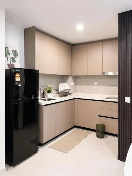 Kitchen features: black refrigerator, light brown cabinetry, white countertop, black sink, chrome faucet, built-in stove, tile backsplash, kitchen towel holder, decorative plant, beige area rug, under-cabinet lighting; style: modern.