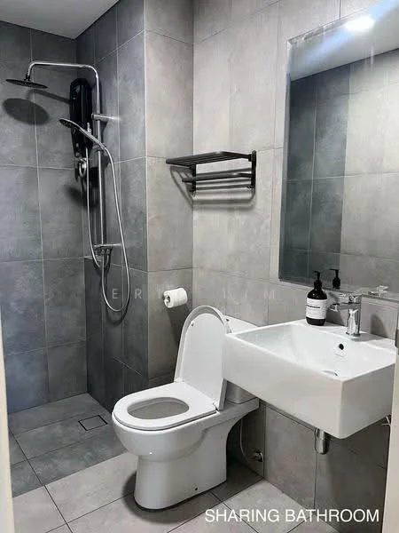 Bathroom features: grey ceramic tile walls, grey ceramic tile flooring, walk-in shower with glass enclosure, rain shower head, handheld shower, toilet, single-sink vanity with wall-mounted faucet, mirror above sink, towel rack, soap dispenser, toilet paper holder; style: modern.