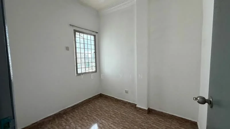 Room features: white painted walls, brown tiled flooring, single window with metal grille, ceiling with crown moulding, light switch, door handle.