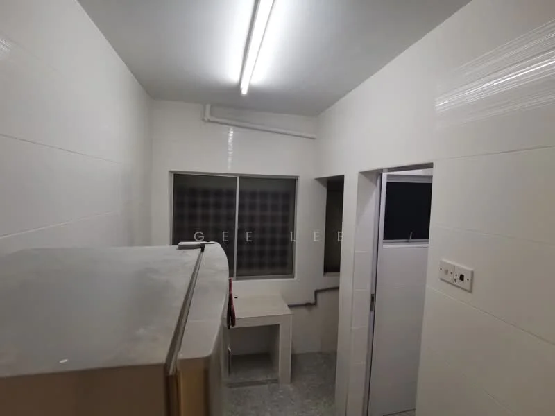 Room features: white tiled walls, grey flooring, fluorescent ceiling lights, window with grid pattern, sink with countertop, refrigerator, doorway leading to another room, pipe fittings visible; style: modern.