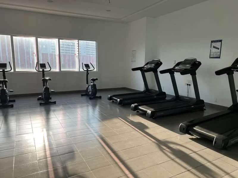 Room features: treadmills, stationary bikes, large windows, grey tiled flooring, white painted walls, ceiling lights, exercise equipment, natural light; style: modern; view: city.