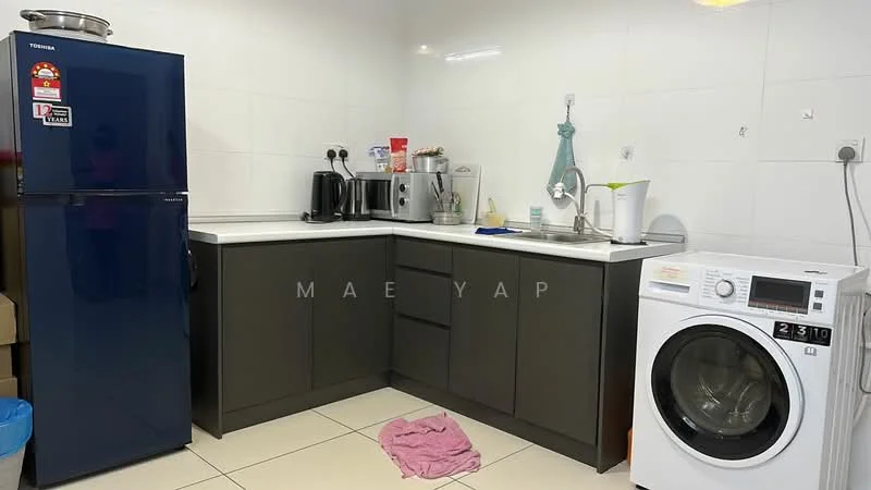 Kitchen features: blue refrigerator, stainless-steel sink, chrome pull-down faucet, grey cabinetry, white countertop, built-in microwave, toaster, kettle, front-load washing machine, tile flooring, white tiled walls, wall-mounted electrical outlets, pink cloth on the floor; style: modern.