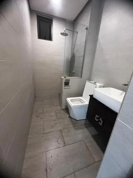 Bathroom features: grey ceramic tile flooring, light grey wall tiles, glass shower enclosure, rain shower head, single-sink vanity with white countertop, dark wood cabinet, one-piece toilet, small window for natural light, recessed lighting; style: modern.