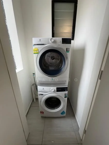 Laundry features: stacked front-load washing machine, front-load dryer, white appliances, tile flooring, neutral wall colour, small window for natural light, plumbing connections visible, vent for dryer; style: modern.