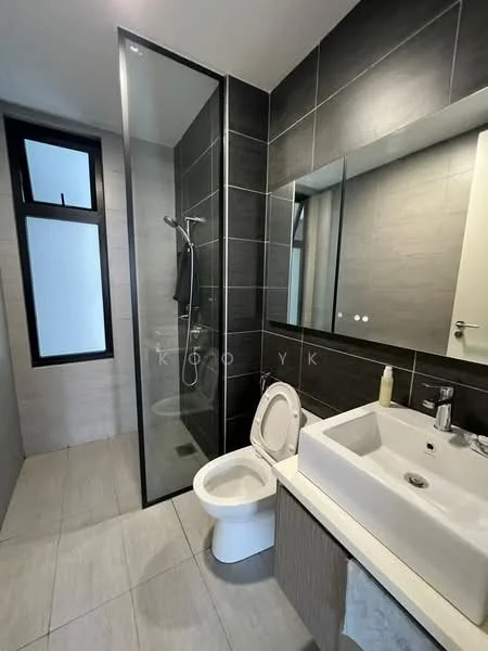 Bathroom features: walk-in shower with glass enclosure, chrome handheld shower, single-sink vanity with wood cabinet, white ceramic sink, chrome basin mixer, framed mirror, one-piece toilet, grey tile flooring, grey wall tiles, black accent wall, window for natural light; style: modern.