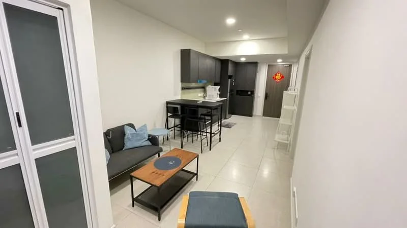 Living features: grey fabric sofa, wood coffee table, black dining table with four chairs, white walls, tile flooring, recessed ceiling lights, kitchenette with black cabinetry, blue decorative cushions, open layout, floor-to-ceiling windows, door to hallway, decorative wall art; style: modern.