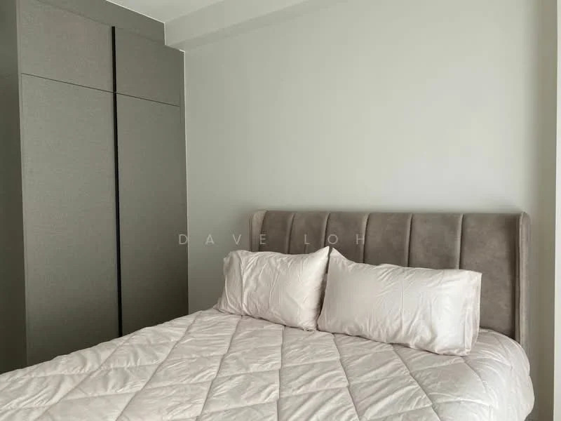Bedroom features: king-size bed with upholstered headboard, two decorative pillows, light grey wall, built-in wardrobe with grey finish, bedside area with no visible decor, neutral bedding, minimalist design, natural light from window; style: modern.