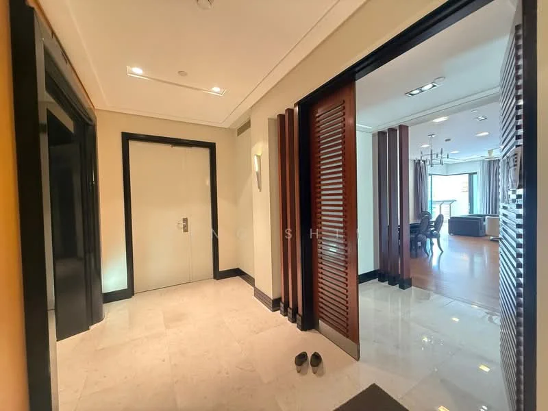 Room features: marble flooring, white painted walls, recessed downlights, wooden door, sliding wooden door, decorative wall paneling, shoe rack, open layout, natural light from adjacent room; style: modern.