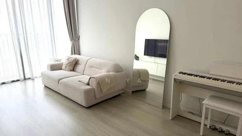 Living features: light grey fabric sofa, large mirror, white piano, white side table, floor-to-ceiling windows, sheer curtains, light wood flooring, TV console, wall-mounted TV; style: modern; view: city.