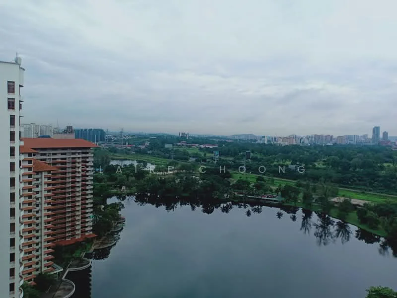 Exterior type: high-rise condominium; features: glass curtain wall, red brick facade, recessed balconies, surrounded by mature greenery, waterfront view, city skyline in background; style: modern.