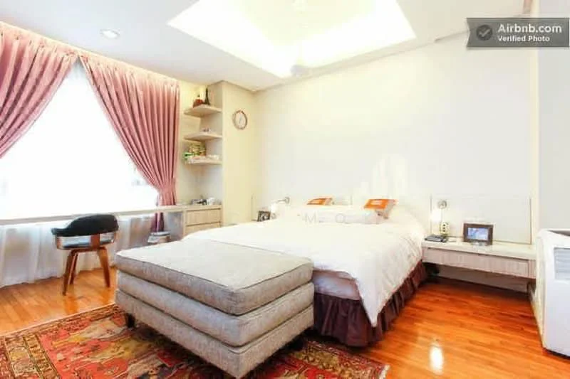 Bedroom features: king-size bed, upholstered headboard, wooden bedside tables, table lamp, built-in wardrobe, wooden flooring, large window with sheer curtains, decorative wall clock, sitting area with small table, recessed ceiling with lighting; style: modern.