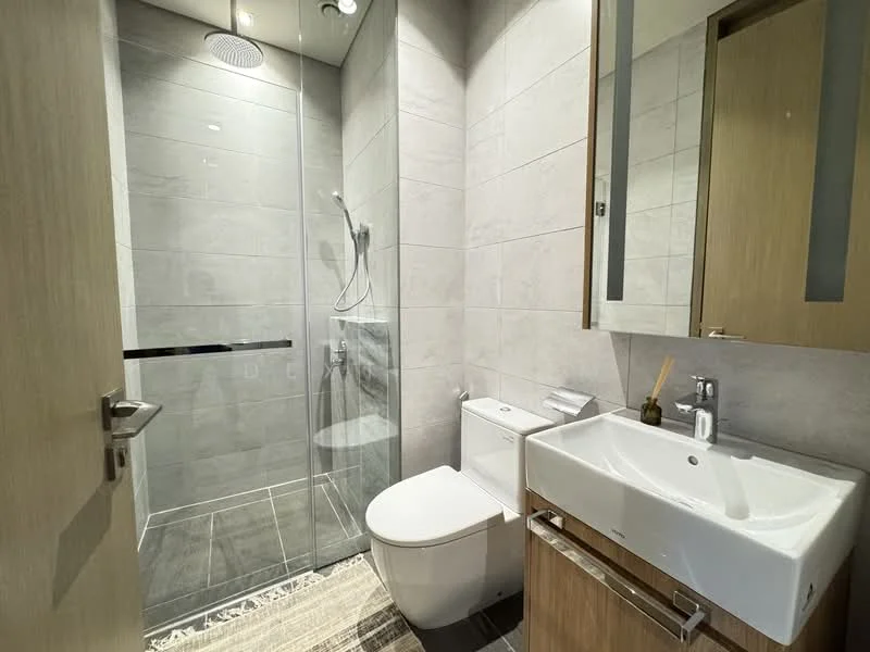 Bathroom features: grey tiled walls, grey tiled flooring, walk-in shower with glass enclosure, rain shower head, handheld shower, single-sink vanity with wood cabinet, chrome basin mixer, one-piece toilet, framed mirror, recessed downlights, towel rack; style: modern.