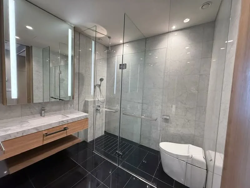 Bathroom features: marble tile walls, black ceramic tile flooring, glass shower enclosure, rain shower head, handheld shower, single-sink vanity with wood cabinet, mirror with integrated lighting, one-piece toilet, chrome basin mixer faucet, recessed downlights; style: modern.