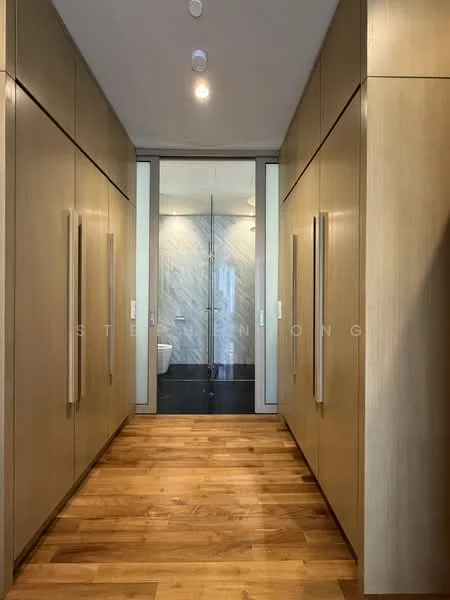 Room features: wooden flooring, built-in cabinetry with wooden finish, recessed lighting, glass door leading to bathroom, marble wall cladding, black tile flooring in bathroom, neutral color palette; style: modern.