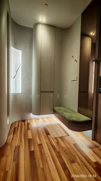 Room features: wooden flooring, curved wall, built-in cabinetry, green bench seating, recessed lighting, wall-mounted mirror, decorative branch feature, neutral wall color; style: modern.