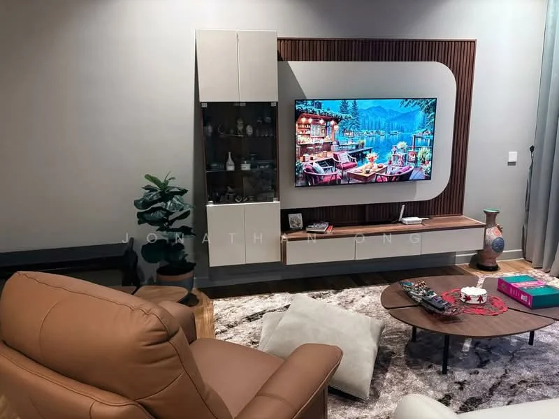 Living features: leather sofa in brown, coffee table with round top, wall-mounted TV, TV console with storage, decorative wall panel with wood accents, area rug with geometric pattern, potted plant, decorative vase, remote control on table, wall with grey paint; style: modern.