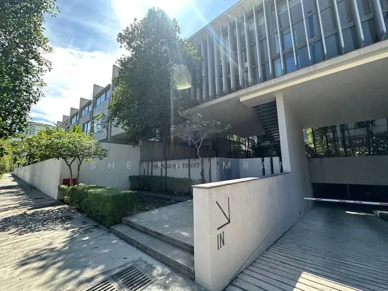 Exterior type: low-rise apartment block; features: modern facade with vertical fins, concrete wall, landscaped garden with trees, paved walkway, parking area, large windows, surrounded by greenery; style: modern.