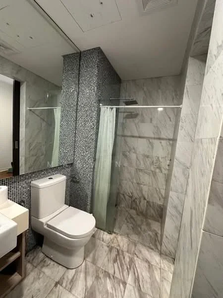 Bathroom features: white toilet, walk-in shower with glass enclosure, rain shower head, grey marble wall tiles, mosaic tile accent wall, light grey marble floor tiles, single-sink vanity with wood cabinet, mirror above vanity, shower curtain, chrome fixtures; style: modern.