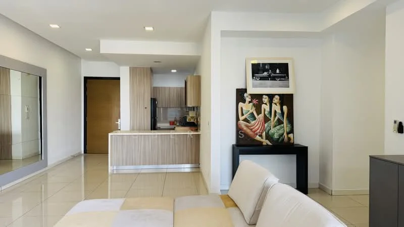 Living features: cream painted walls, white ceiling, recessed downlights, large mirror, tile flooring, 3-seater beige sofa, decorative artwork, black console table, open kitchen layout; style: modern. Kitchen features: wood cabinetry, black appliances, kitchen island, countertop with overhang; style: modern.