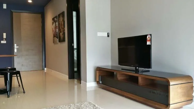 Living features: grey painted walls, glossy tile flooring, wooden TV console, flat-screen TV, black decorative accents, framed artwork on wall, door leading to hallway, recessed lighting, open layout, area rug; style: modern.