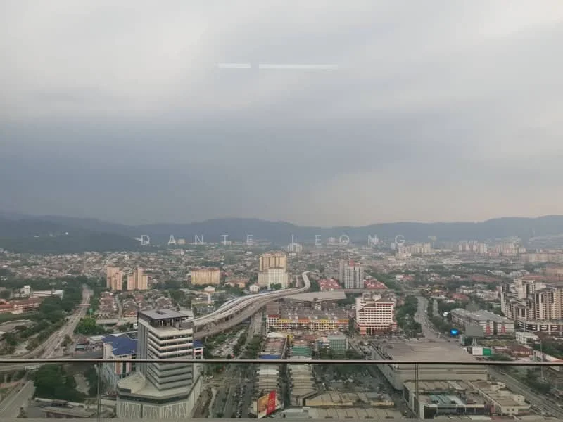 Exterior type: high-rise condominium; features: city skyline view, surrounded by urban landscape, visible transportation infrastructure, mountain backdrop, cloudy sky, high-rise buildings in the foreground; style: modern.