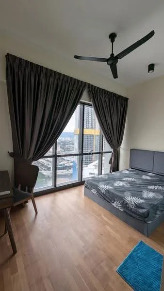 Bedroom features: king-size bed, upholstered headboard, floor-to-ceiling windows, dark grey curtains, wooden flooring, ceiling fan, study desk, chair, area rug with geometric pattern; style: modern; view: city.