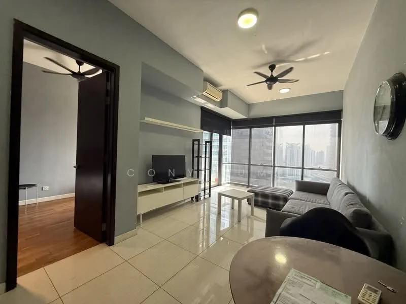 Living features: grey L-shape sectional sofa, white coffee table, TV console, wall-mounted TV, ceiling fan with light, recessed downlights, large floor-to-ceiling windows, wooden flooring, decorative wall clock, light blue painted walls, black window treatments; style: modern; view: city. Room features: dark wooden door, light grey walls.