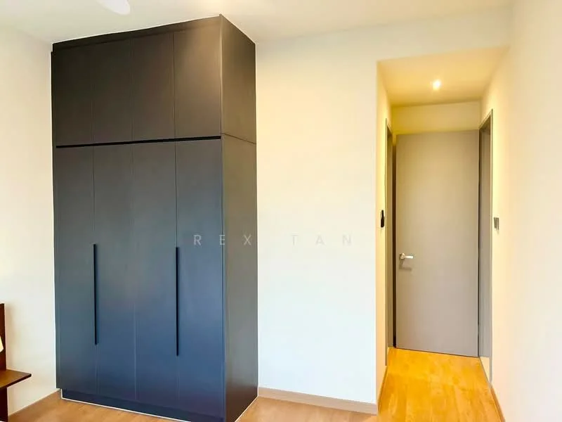 Room features: built-in wardrobe with black finish, light wood flooring, neutral painted walls, door leading to hallway, recessed lighting, door frame with grey finish; style: modern.